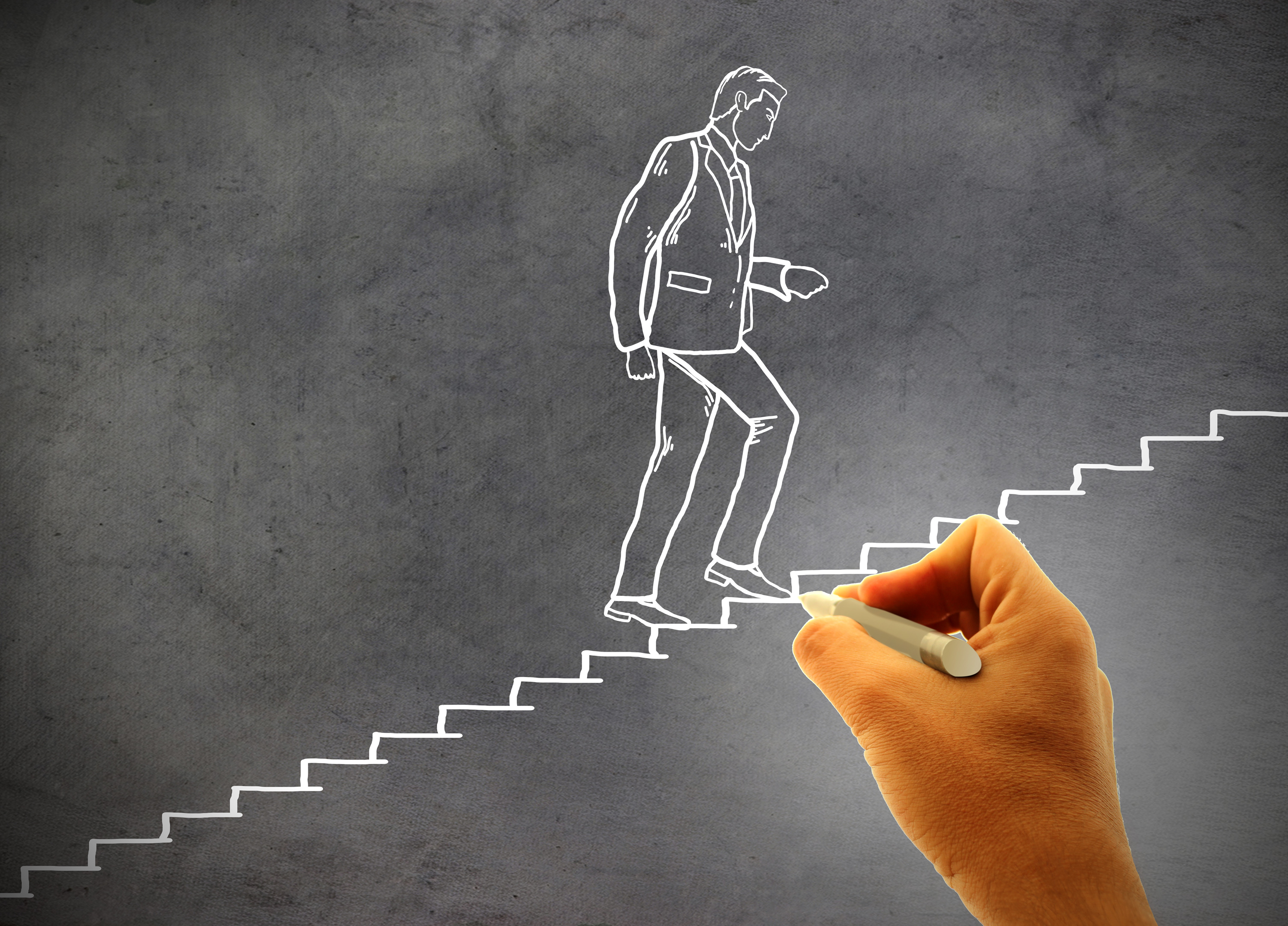 Businessman climbing staircase - Concept of climbing the career ladder